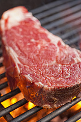 USA, Texas, Grilling rib eye steak, close up - ABAF000153