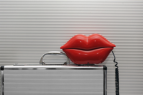 Lip shaped telephone on briefcase, close up - LRF000550