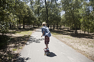 France, Boy longboarding on road - MSF002741