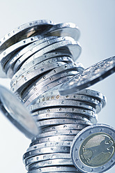 Euro coins collapsing against white background, close up - WBF001368