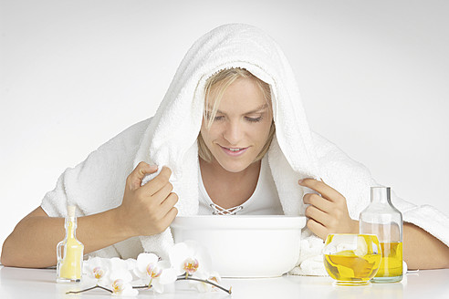 Young woman using aromatherapy oil, close up - WBF001384