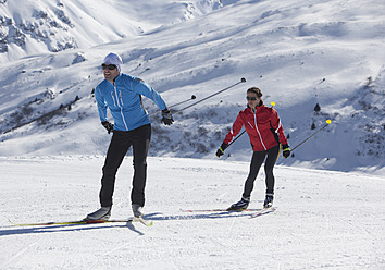 Germany, Man and woman skiing in snow - WBF001478