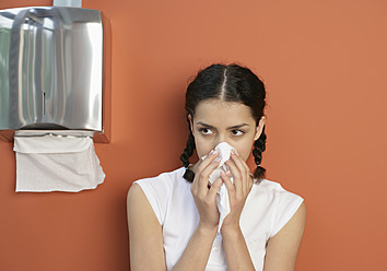 Young woman sneezing, close up - WBF001426