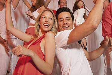 Germany, Stuttgart, Group of people dancing in nightclub, smiling - WBF001451