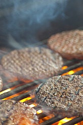 USA, Texas, Burger patties on barbecue grate - ABAF000223