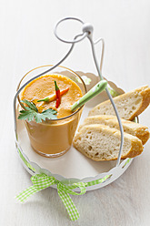 Glass of gazpacho with chillies, bread and parsley on tray - ECF000089