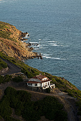 Italy, Sardinia, Nebida, View of cottage by Mediteranian Sea - KAF000010