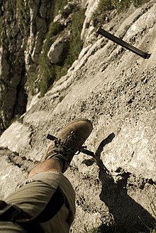 Germany, Bavaria, Man climbing mountain - KAF000018