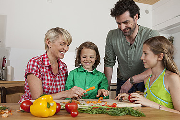 Germany, Bavaria, Nuremberg, Family cutting vegetables - RBYF000155