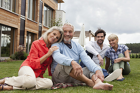 Deutschland, Bayern, Nürnberg, Porträt einer Familie vor einem Haus sitzend - RBYF000219
