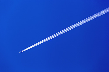 Austria, Aeroplane with contrail against blue sky - EJWF000083