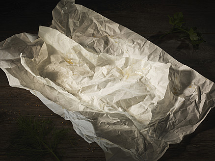 Used food packing paper on wooden table - CHF000002