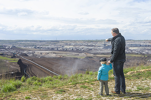 Germany, Saxony, Schleenhain, Father showing brown coal mining to son - MJ000132