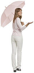 Young woman with umbrella checking for rain, smiling - WBF001486