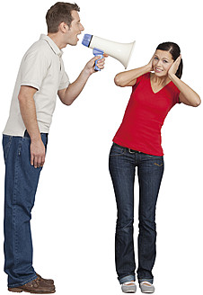 Mid adult man with megaphone shouting on young woman - WBF001518