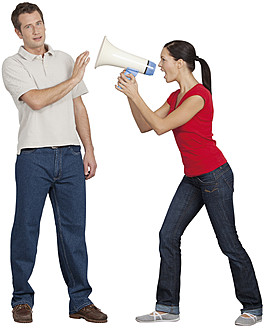 Young woman with megaphone shouting on mid adult man - WBF001519