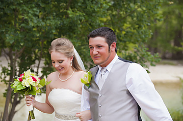 USA, Texas, Bride and groom smiling, close up - ABAF000264