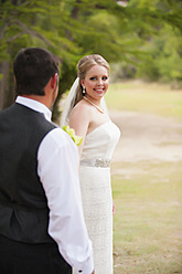 USA, Texas, Bride and groom looking at each other, smiling - ABAF000256