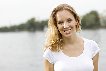 Germany, Berlin, Young woman smiling, portrait - FKF000060