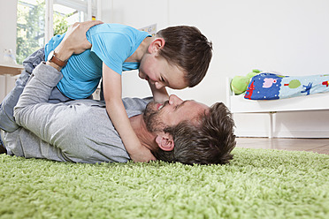 Germany, Berlin, Father and son having fun at home, smiling - RBF000950