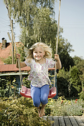 Germany, Bavaria, Girl swinging on swing - RNF001037