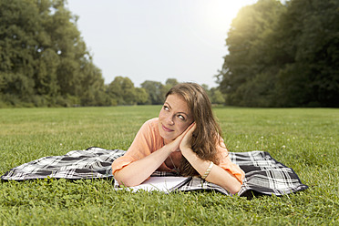 Germany, Berlin, Young student learning in Treptower Park - FKF000066