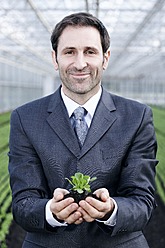 Germany, Bavaria, Munich, Mature man in greenhouse with corn salad - RREF000074