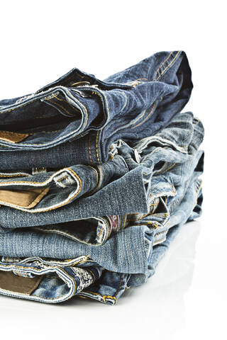 Variety of blue jeans on white background, close up stock photo