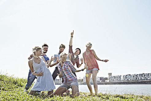 Germany, Cologne, Group of people playing air guitar - RHYF000241