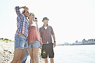 Germany, Cologne, Men and woman looking away - RHYF000264