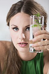 Germany, Young woman holding glass of water - RFMYF000020