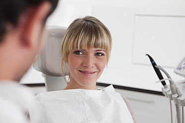 Germany, Young woman in dentist chair, smiling - FMKYF000198