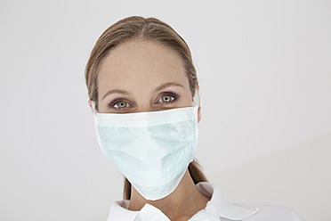 Germany, Close up of dentist with surgical mask - FMKYF000215