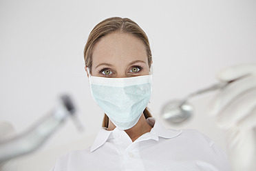 Germany, Close up of dentist with surgical mask - FMKYF000216