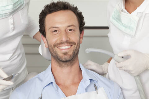 Germany, Mid adult man getting his teeth examined by dentist stock photo