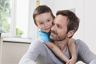 Germany, Berlin, Father and son at home, smiling, portrait - RBF001047