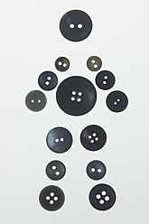 Various buttons arranged in shape of figurine, close up - ASF004634