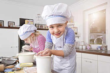 Germany, Girl and boy making dough in kitchen - FKF000082