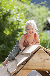 Germany, Girl playing on playground - TCF002936