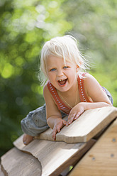 Germany, Girl playing on playground - TCF002937