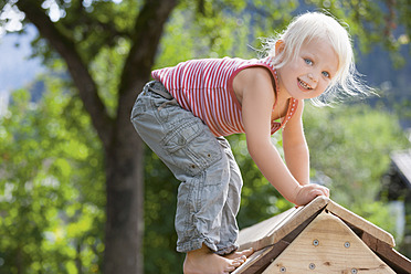 Germany, Girl playing on playground - TCF002938