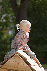 Germany, Girl playing on playground - TCF002947
