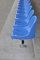 Germany, Bavaria, Munich, Stand with blue plastic seats - AXF000334