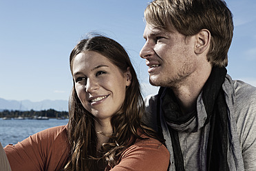Germany, Bavaria, Couple sitting on jetty at Lake Starnberg - RBF001059