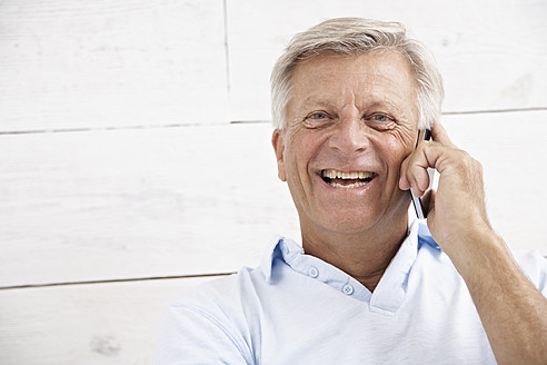 Spanien, älterer Mann, der mit dem Handy spricht, lächelnd, Porträt - PDYF000138