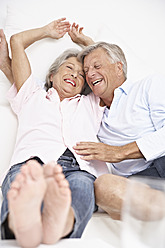 Spain, Senior couple waking up, smiling - PDYF000141