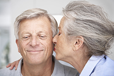 Spain, Senior woman kissing to man, close up - PDYF000158