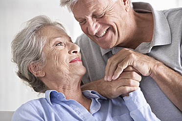 Spanien, älteres Paar, das sich lächelnd ansieht - PDYF000174