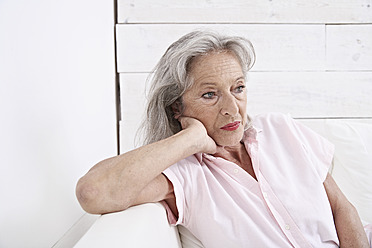 Spain, Mallorca, Sad senior woman sitting on couch - PDYF000192