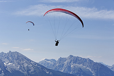Germany, Bavaria, Paraglider flying over Berchtesgaden Alps - SIEF002884